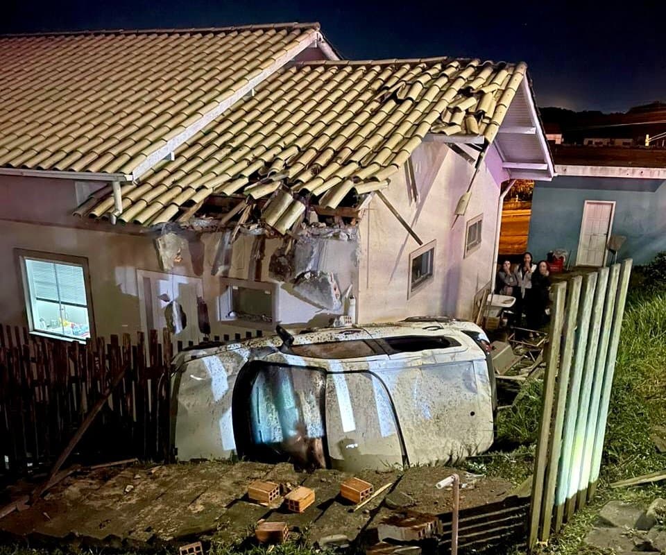 Carro bate em casa, tomba e assusta moradores